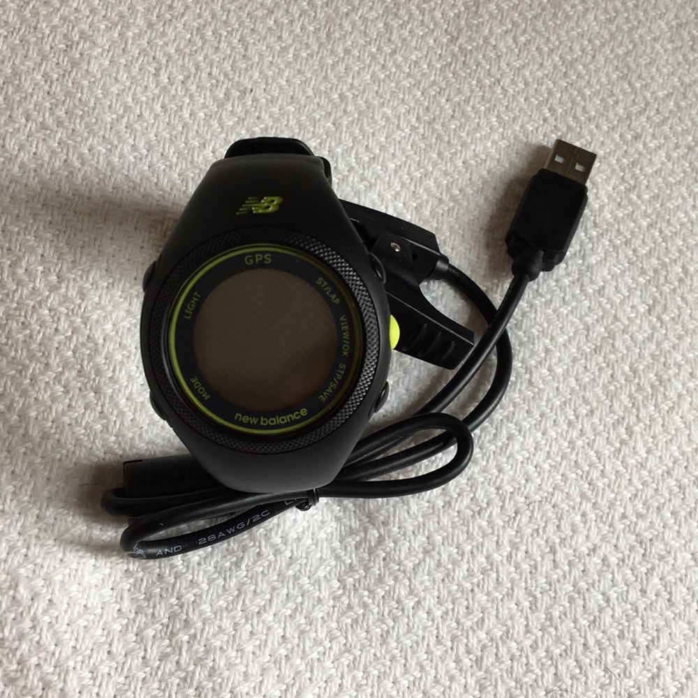 New Balance GPS watch with charger.